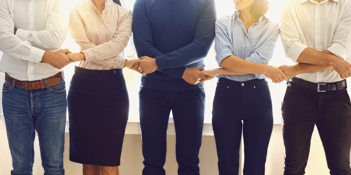 People holding hands | Employee Benefits