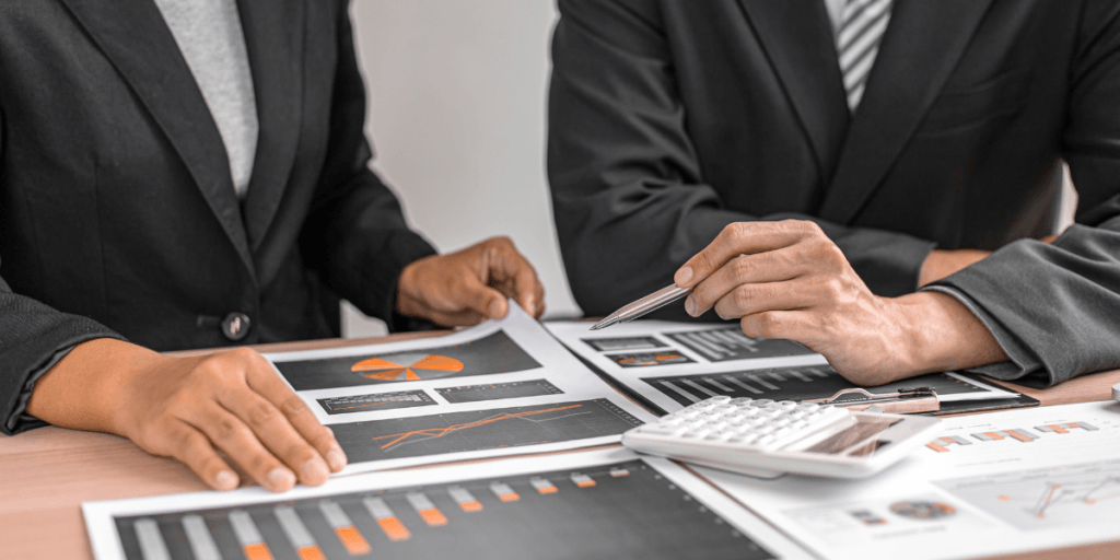 business insurance renewal | Business men looking over graphs